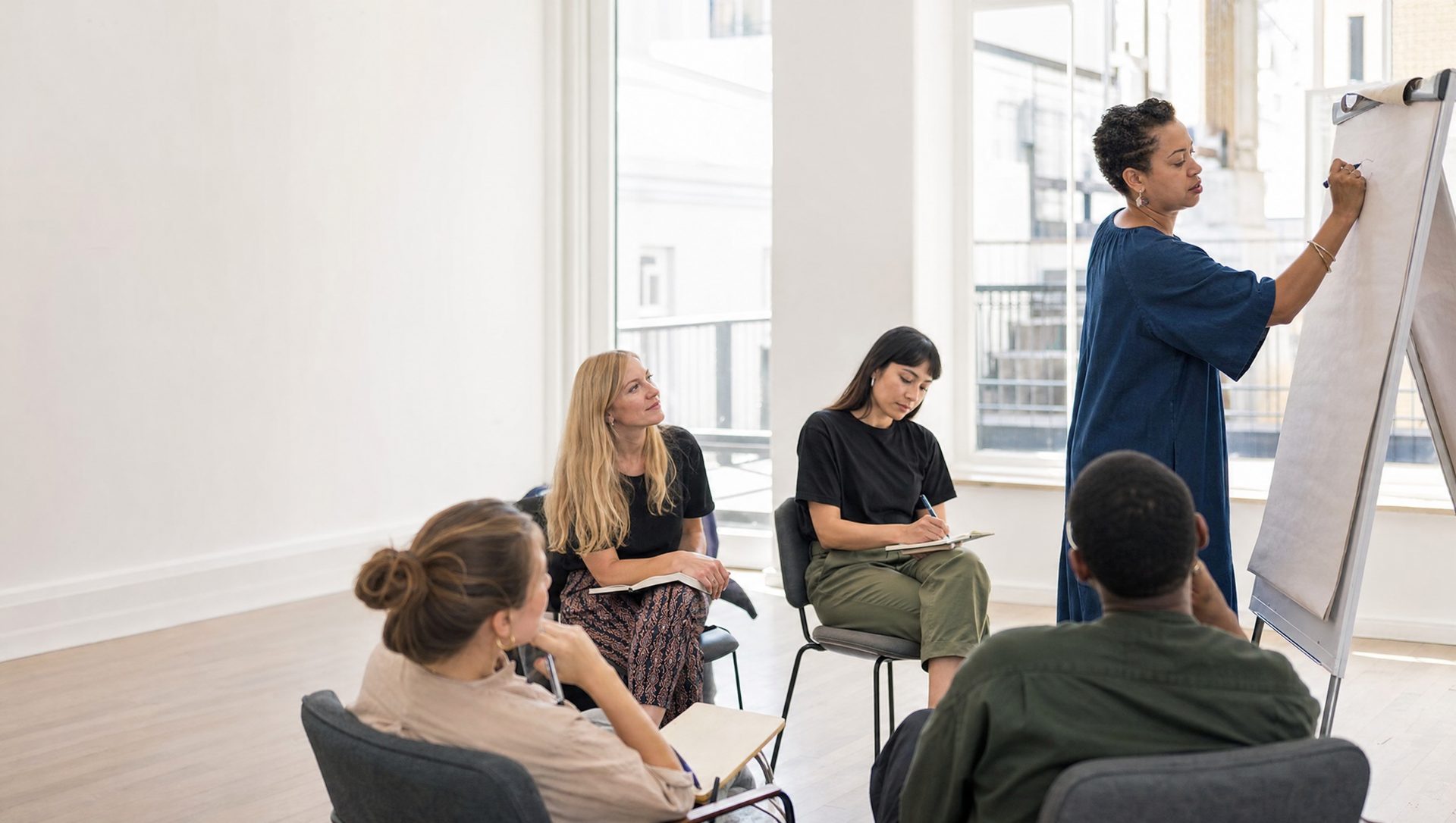 A small group taking notes in a workshop